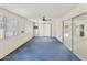 A bright sun room has a ceiling fan, light walls, blue carpet, and sliding glass doors to other parts of the house at 26622 S Beech Creek Dr, Sun Lakes, AZ 85248