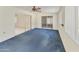 A bright sun room has a ceiling fan, light walls, blue carpet, and sliding glass doors to other parts of the house at 26622 S Beech Creek Dr, Sun Lakes, AZ 85248