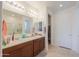 Bathroom featuring a double sink vanity, large mirror, and a separate shower area at 346 E Tahiti E Dr, Casa Grande, AZ 85122