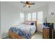 Bedroom with a ceiling fan, natural light, and wood furniture at 346 E Tahiti E Dr, Casa Grande, AZ 85122