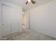Bedroom with a ceiling fan, light carpet and closet with sliding doors at 346 E Tahiti E Dr, Casa Grande, AZ 85122