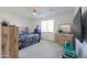Cozy bedroom with a comfortable bed, dresser, and ample natural light from a window at 346 E Tahiti E Dr, Casa Grande, AZ 85122