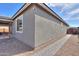 Side view of home displaying textured exterior, window, rock landscaping and brick walkway at 346 E Tahiti E Dr, Casa Grande, AZ 85122