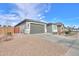 Home exterior with a two-car garage and desert landscaping at 346 E Tahiti E Dr, Casa Grande, AZ 85122