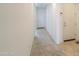 Inviting hallway with neutral carpet and paint leads to a bright white front door at 346 E Tahiti E Dr, Casa Grande, AZ 85122