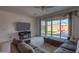 Cozy living room with a modern sectional sofa and sliding doors to the backyard at 346 E Tahiti E Dr, Casa Grande, AZ 85122