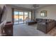 Comfortable living room with a large sectional sofa and sliding door access to backyard at 346 E Tahiti E Dr, Casa Grande, AZ 85122