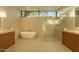 Modern bathroom featuring a freestanding tub, glass-enclosed shower, and dual vanities at 3643 E Coolidge St, Phoenix, AZ 85018