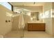 Bright bathroom with glass shower, stone tile and vanity at 3643 E Coolidge St, Phoenix, AZ 85018
