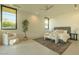 Bright bedroom with neutral decor, large windows and a comfortable sitting area at 3643 E Coolidge St, Phoenix, AZ 85018