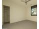 Spacious bedroom with neutral carpet, walk-in closet, and a black framed window at 3643 E Coolidge St, Phoenix, AZ 85018