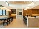 Open dining area with modern light fixtures, bar seating, and connection to the kitchen and living spaces at 3643 E Coolidge St, Phoenix, AZ 85018