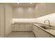 Well-lit laundry room with ample cabinet space and a stainless steel sink at 3643 E Coolidge St, Phoenix, AZ 85018