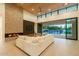 Bright living room featuring high ceilings, a brick fireplace, and sliding doors to the backyard pool at 3643 E Coolidge St, Phoenix, AZ 85018