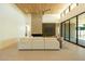 Bright living room featuring high ceilings, a brick fireplace, and sliding doors to the backyard at 3643 E Coolidge St, Phoenix, AZ 85018