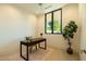 Bright office space with a large window offering views of lush greenery and a dark wood desk at 3643 E Coolidge St, Phoenix, AZ 85018