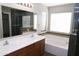 Bathroom features double sinks, soaking tub and tiled walk in shower at 4114 S Sawmill Rd, Gilbert, AZ 85297