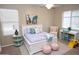 Charming bedroom with a white bed frame, colorful accents, and ample natural light at 4114 S Sawmill Rd, Gilbert, AZ 85297