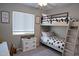 Playful ' bedroom featuring a bunk bed, themed bedding, and a bright window at 4114 S Sawmill Rd, Gilbert, AZ 85297