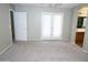 Spacious primary bedroom with neutral carpet, light paint, ceiling fan and ensuite bathroom access at 4114 S Sawmill Rd, Gilbert, AZ 85297