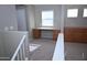 View of the bonus room that features built-in cabinets and desk space, located at the top of stairs at 4114 S Sawmill Rd, Gilbert, AZ 85297