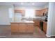 Open kitchen features a granite island countertop, stainless steel appliances, and wood cabinets at 4114 S Sawmill Rd, Gilbert, AZ 85297