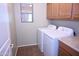 Laundry room with cabinets, a window, a washer, and a dryer at 4114 S Sawmill Rd, Gilbert, AZ 85297