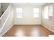Open living space featuring a staircase, tile flooring, neutral colored walls, and bright windows at 4114 S Sawmill Rd, Gilbert, AZ 85297