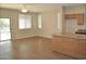 Open living room with tile floors off the kitchen that has a slider to the back yard at 4114 S Sawmill Rd, Gilbert, AZ 85297