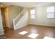 Open living space featuring a staircase, tile flooring, neutral colored walls, and bright windows at 4114 S Sawmill Rd, Gilbert, AZ 85297