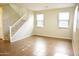 Open living space featuring a staircase, tile flooring, neutral colored walls, and bright windows at 4114 S Sawmill Rd, Gilbert, AZ 85297