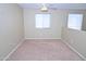 Empty carpeted loft space with neutral walls and natural light from the windows at 4114 S Sawmill Rd, Gilbert, AZ 85297