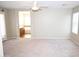 Large primary bedroom offers plush carpet, neutral colors, a ceiling fan, and bathroom access at 4114 S Sawmill Rd, Gilbert, AZ 85297