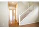 Carpeted staircase in the entry way with tile flooring and light-colored walls at 4114 S Sawmill Rd, Gilbert, AZ 85297