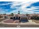 Single-story home with a two-car garage and landscaped yard at 5003 W Davis Rd, Glendale, AZ 85306