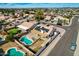 An aerial view showcasing a house with a pool and solar panels at 5003 W Davis Rd, Glendale, AZ 85306