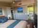 Virtually staged bedroom with a king-size bed and access to balcony at 5150 N 20Th St # 201, Phoenix, AZ 85016