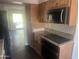 Kitchen with wood cabinets, granite counters, and a breakfast bar at 5150 N 20Th St # 201, Phoenix, AZ 85016