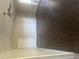 Spacious living area with dark tile floors and a ceiling fan at 5150 N 20Th St # 201, Phoenix, AZ 85016