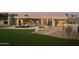 Wide shot of the luxurious backyard with a spa, pool, outdoor seating, and a well-manicured lawn at 5327 N Invergordon Rd, Paradise Valley, AZ 85253