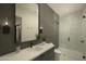 Sleek bathroom featuring dark tile, a glass-enclosed shower, and modern fixtures at 5327 N Invergordon Rd, Paradise Valley, AZ 85253