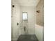 Modern bathroom featuring glass enclosed shower, a wall shower head and decorative tile at 5327 N Invergordon Rd, Paradise Valley, AZ 85253