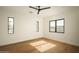 Bright bedroom with hardwood floors, ceiling fan, and multiple windows showcasing desert landscaping at 5327 N Invergordon Rd, Paradise Valley, AZ 85253
