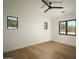 Bright, empty bedroom features hardwood floors and multiple windows for great natural light at 5327 N Invergordon Rd, Paradise Valley, AZ 85253
