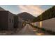 Long driveway lined with desert landscaping leading to a modern home with mountain views at 5327 N Invergordon Rd, Paradise Valley, AZ 85253