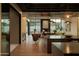 Modern kitchen with natural wood, large windows, and seamless transition to living space at 5327 N Invergordon Rd, Paradise Valley, AZ 85253