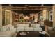 Open-concept living space with a sectional sofa, kitchen view, and modern design elements at 5327 N Invergordon Rd, Paradise Valley, AZ 85253