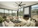 Sunlit living room featuring a black fireplace, neutral decor, and backyard views at 5327 N Invergordon Rd, Paradise Valley, AZ 85253