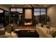 Comfortable living room featuring a fireplace, a large sectional sofa, accent chairs, and expansive outdoor views at 5327 N Invergordon Rd, Paradise Valley, AZ 85253