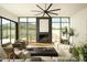 Bright living room featuring a stone fireplace, large sectional sofa, and expansive desert views at 5327 N Invergordon Rd, Paradise Valley, AZ 85253